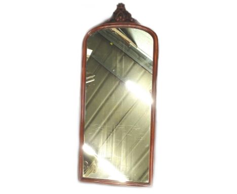 A Victorian mahogany wall mirror, the arched plate with a pierced 'C' scroll crest, 138cm H, 58cm W.Provenance: The property 