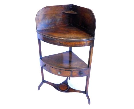 A George III mahogany and ebony inlaid corner wash stand, with a raised back, above a later top enclosing recesses for bowls 