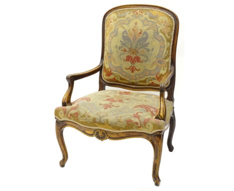 A late 19th/early 20thC Continental walnut open armchair, upholstered in woolwork tapestry type fabric, with a moulded showfr