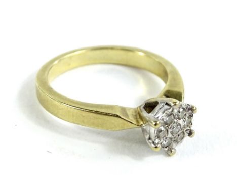 A 9ct gold dress ring, in the form of a flower and set with round brilliant cut diamonds, totalling approx 0.10cts and marked