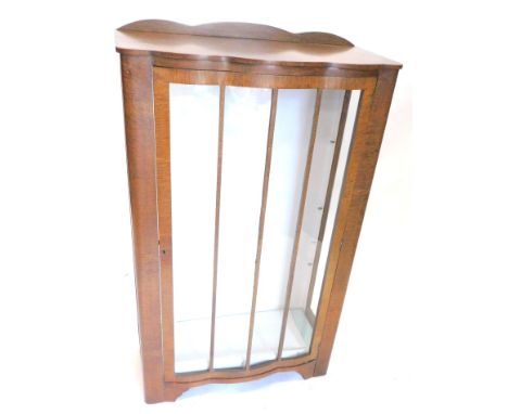 An Art Deco oak display cabinet, with a raised back above a single glazed door, on bracket feet, 72cm W.