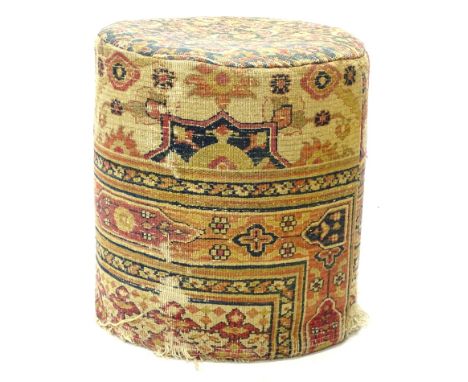 An early 20thC carpet covered cylindrical pouffe, with geometric design in red, black, cream etc., 48cm H, 44cm dia.Provenanc