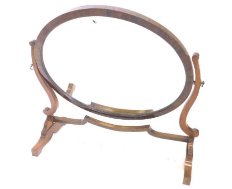 A mahogany swing frame dressing table mirror, the oval plate, on shaped supports with trestle type base, 70cm W.