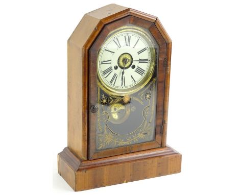 A late 19thC American mantel clock, the paper dial with Roman numerals, the arched glazed door with gilt verre eglomise decor