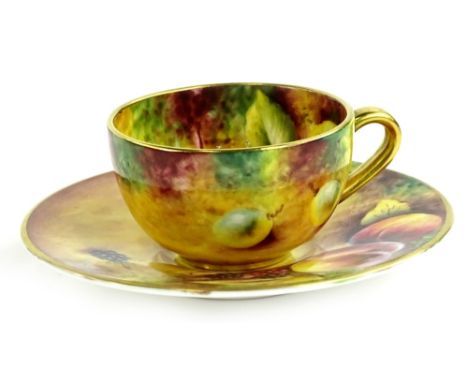 A Royal Worcester porcelain cup and saucer, painted with fruit by T Knott, printed mark in black to underside.