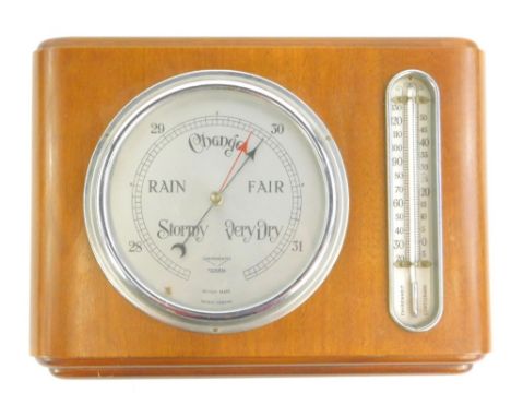 A Federal brand aneroid barometer, with silvered dial and thermometer in a walnut case, 34cm W.