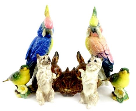 A collection of ceramic animals, to include two Karl Ens parrots, a Goebel group of three rabbits, two Royal Doulton terriers
