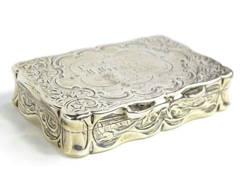 A Victorian silver rectangular snuff box, engraved with scrolls, the cartouche engraved "presented to J Graham etc. 1878", Bi