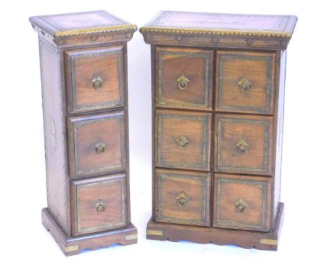 Two similar Eastern hardwood three drawer chests, each applied with pierced and hammered brass on bracket feet, the largest 4