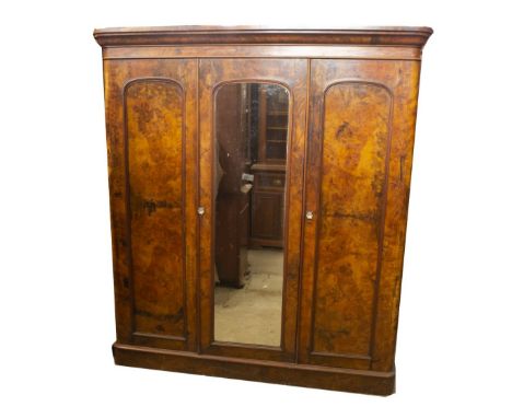 A Victorian figured walnut triple wardrobe compactum, with moulded cornice, central mirror door, with panel door to the left 