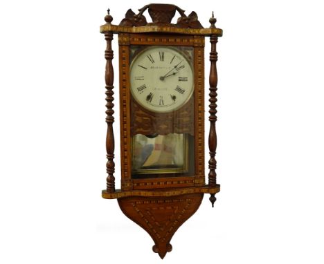 A late 19thC American walnut and parquetry wall clock, the painted dial stamped Skarratt and Co Worcester, with turned pillar