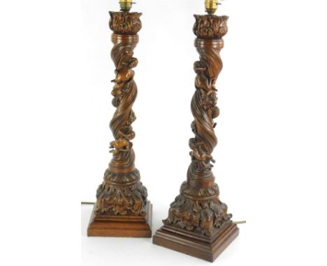 A pair of late 19th/early 20thC carved Italian lamp bases, each decorated with three putti on a spiral column and leafy base 