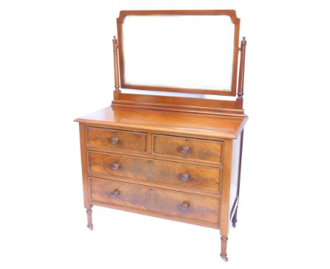 A late 19th/early 20thC mahogany dressing table, the rectangular bevelled mirror plate on turned supports, the base with two 
