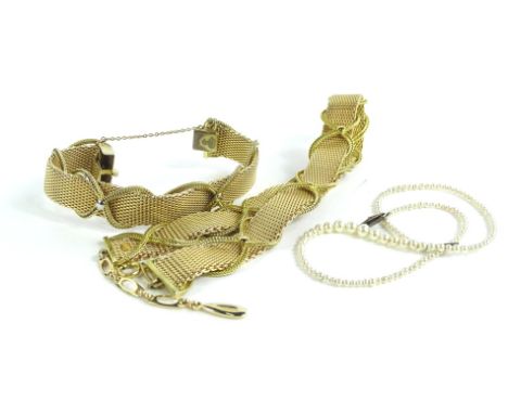 A gilt metal bracelet stamped Christian Dior, Gross, Germany, a matching necklace stamped Christian Dior and a single string 