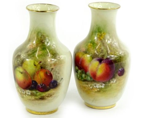 A pair of Royal Worcester small porcelain vases, each painted with fruit by Rickells, printed mark in puce to underside, 12cm