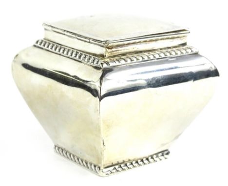 A silver sugar box or tea caddy, of square tapering form with gadrooned bands and a hinged lid, marks indistinct, 3½oz.