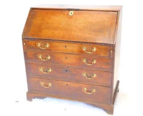 A George III oak bureau, the fall enclosing a fitted interior over four graduated drawers, with later brass drop handles, on 