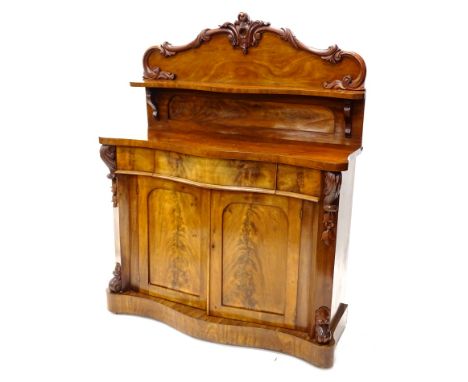 A Victorian mahogany chiffonier, the raised back carved with scrolls and with a shaped shelf, the base with a frieze drawer a