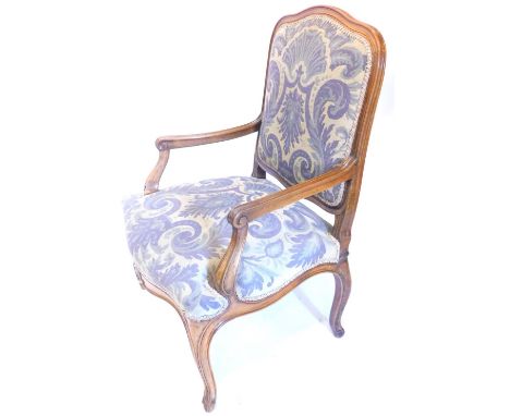 A Continental walnut open armchair, with a padded back and seat, upholstered in tapestry type fabric, on cabriole legs.Proven