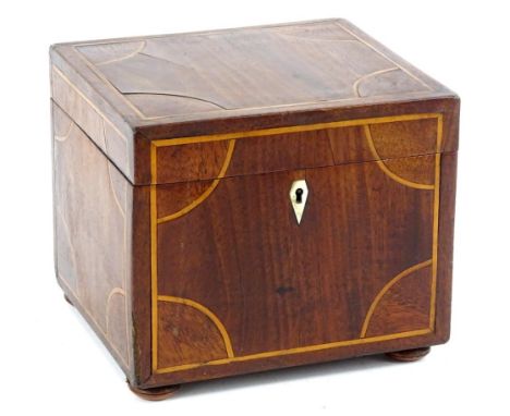 An early 19thC mahogany and inlaid tea caddy, of rectangular form with a plain baize lined interior, elaborate escutcheon, 15