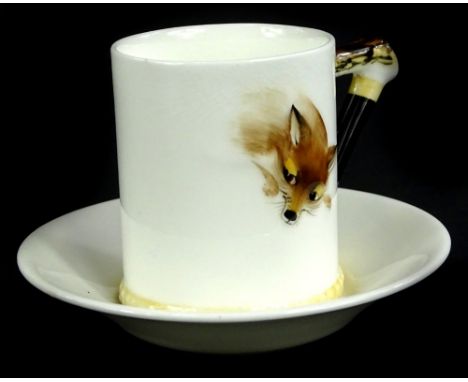 A Royal Doulton Reynard The Fox coffee can and saucer, moulded in relief with a fox and with a stylised hunting whip handle.