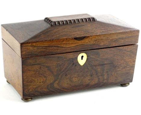 A mid 19thC rosewood sarcophagus shaped tea caddy, the hinged lid enclosing a later paper lined interior and three covers on 