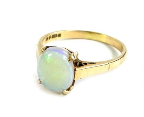 A 9ct gold opal dress ring, the oval cut stone in claw setting, with pierced design shoulders, ring size P, 3g all in. 