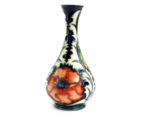 A Moorcroft pottery bottle shaped vase, decorated with a design of poppies, various impressed marks to underside, dated 1996,