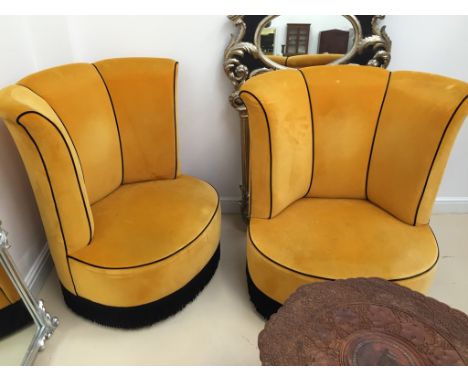 A pair of "Memphis Group" high back chairs, upholstered in a light coloured gold velvet with black trim and black fringing to