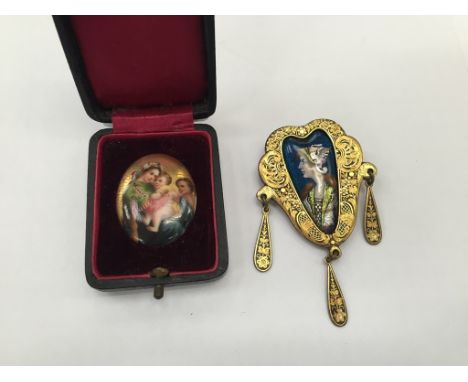 An Art Nouveau brooch with enamelled Valkryie in carved gold mount on steel back with painted ceramic Madonna