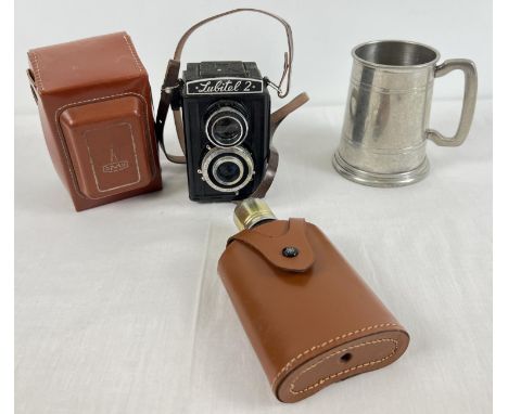 A vintage 'Lubitel 2' box shaped camera with original brown leatherette case. Together with a leather cased hip flask and a p