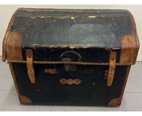 A Victorian dome topped wicker basket trunk with brown leather corners, handles and binding. With interior lift out tray. App