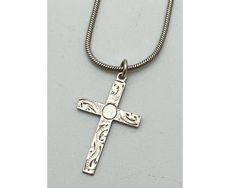 A vintage silver cross pendant with floral decoration to front on an 18" snake chain with lobster clasp. Silver marks to back