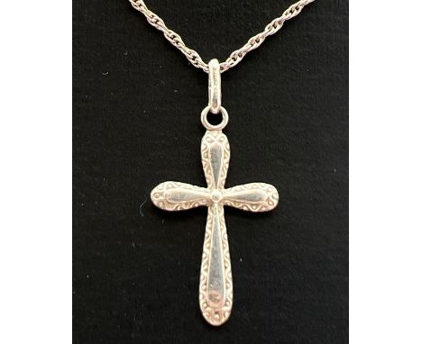 A vintage small silver cross shaped pendant with engraved detail to edges. On an 18" fine rope chain with spring ring clasp. 