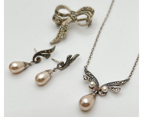 A vintage faux pearl drop fixed pendant necklace with matching drop style earrings. Both set with marcasite stones. Together 