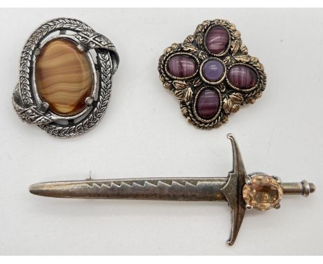 3 vintage stone set brooches by Miracle. To include a sword shaped brooch set with a single pale orange stone and a floral de