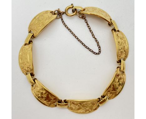 A vintage rolled gold 7 panel bracelet with floral engraved design. With spring ring clasp &amp; safety chain. Stamped to cla