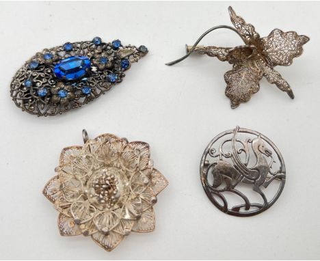 4 pieces of silver and white metal vintage jewellery. A circular silver pierced work Pegasus brooch, a filigree orchid brooch