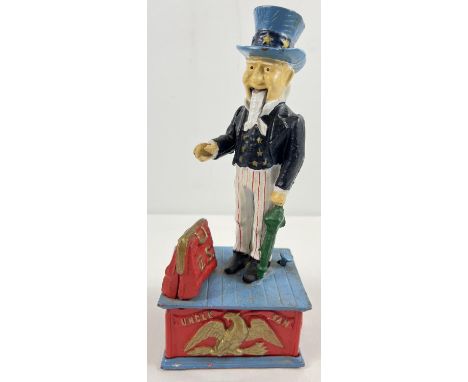 A painted cast iron mechanical "Uncle Sam" money box, with push button action. Arm moves to drop the coin into the opening ba