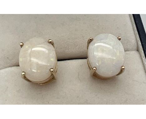 A pair of 9ct yellow gold and opal large stud earrings. Fully hallmarked to posts, opal cabochons approx. 1.25cm x 1cm. Butte