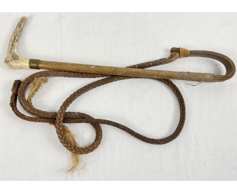 A vintage plaited leather hunting whip with antler horn handle and brass mount. 