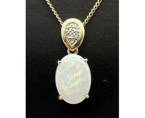 A hallmarked 9ct gold and opal pendant set with 5 small diamonds. On an 18.5" 9ct gold curb chain with spring ring clasp, cla