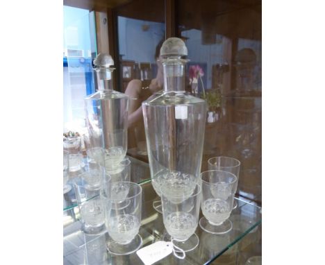 A Renee Lalique Decanter approx 29 cms, together with six glasses approx 6 cms, the decanter having fish form base and stoppe