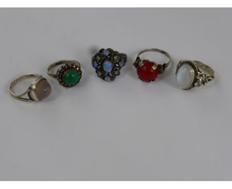 A Miscellaneous Collection of Silver Rings including two moonstone, synthetic opal, and chrysoprase, a red stone. (5)