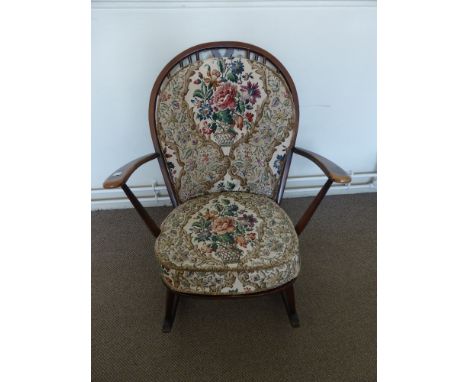 An Ercol Rocking Chair in the Windsor Style, with floral embroidered back and seat.