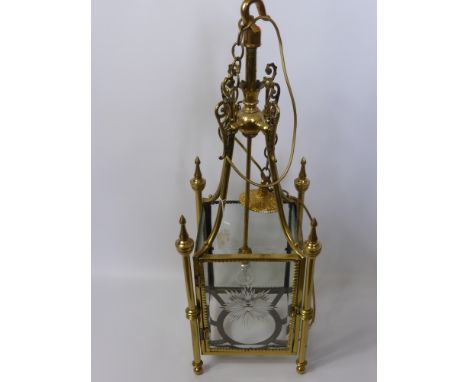 A Brass and Glass Ceiling Lantern, with decorative brass finial's and star engraving to each glass panel, approx 86 x 30 cms.