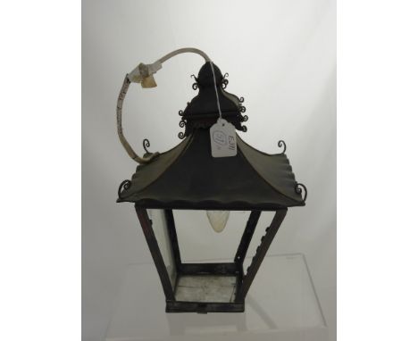 A wrought iron coaching lamp. 