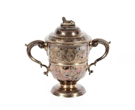 An Irish silver regimental two handled trophy cup, with foliate embossed decoration, acanthus scroll handles and central gird