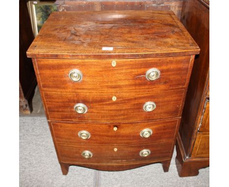 A Georgian mahogany bow fronted commode, having mock four drawer front, opening to reveal a cupboard and pull-out compartment