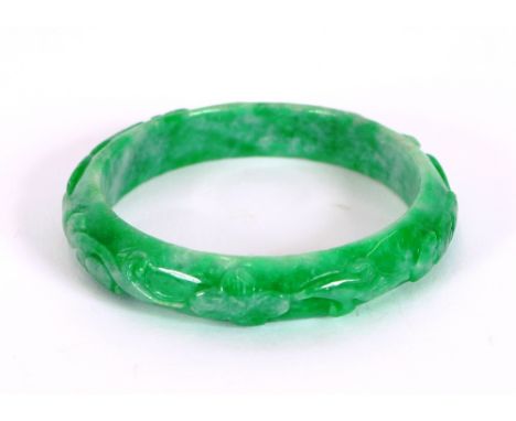 A carved apple green Chinese jade bangle